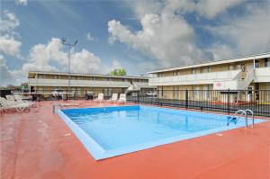 a large swimming pool in front of a building at Alamo Inn & Suites in Gillette