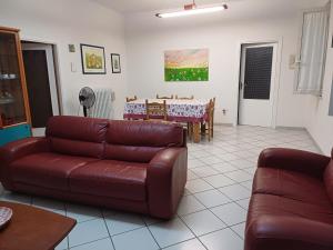 a living room with a couch and a table at La CASA degli IPPOCASTANI in Colonnella