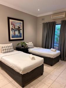 a bedroom with two beds and a window at Tranquility in Margate