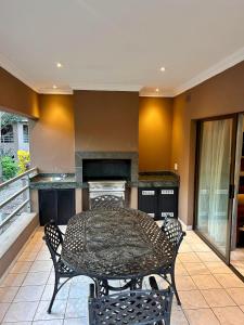 a dining room with a table and chairs in a kitchen at Tranquility in Margate