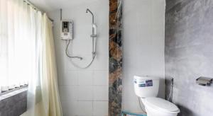 a bathroom with a shower and a toilet at OYO 1012 Vintage Home in Mae Salong