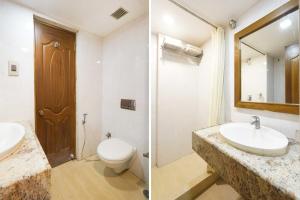 a bathroom with a sink and a toilet and a mirror at Palette Alandur Near Chennai Airport in Chennai +27 photos