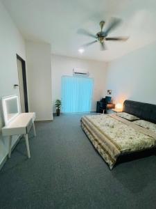 a bedroom with a bed and a ceiling fan at Hm home in Sepang +21 photos
