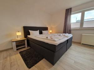 a bedroom with a large bed with a large window at Villa Monika Steuerbord 5 in Sassnitz