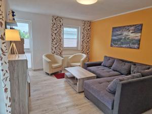 a living room with a couch and a table at Villa Monika Steuerbord 5 in Sassnitz