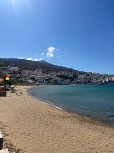 a view of a beach with a city in the background at Cozy house by the sea in Batsi +14 photos