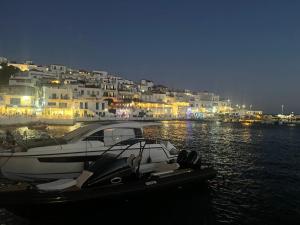 a boat docked in the water in front of buildings at Cozy house by the sea in Batsi