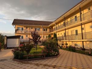 a large building with a bench in front of it at Jany Tilek in Bosteri