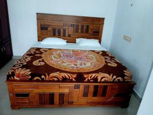 1 cama en un dormitorio con cabecero de madera en Staycation Homestay, en Ernakulam