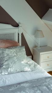a bedroom with a bed and a lamp on a night stand at Domaine du Turbais in Luynes
