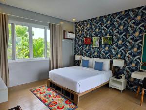 a bedroom with a bed and a wall with a wallpaper at One Hagdan Villas in Boracay +98 photos