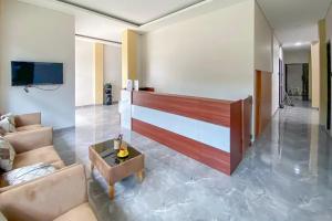 a living room with a couch and a table at Sans Stay Syariah Asyifa Purwokerto in Purwokerto