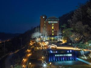 a building with lights in front of it at night at Everrich Hotel in Incheon