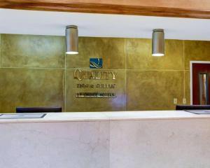 a lobby with a counter with a sign on a wall at Quality Inn & Suites Airport in Austin