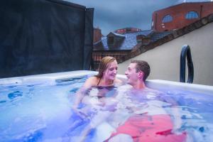 a man and a woman in a hot tub at Chester Apartments in Chester