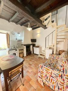 a living room with a couch and a table at Romantic House in Trevignano Romano +28 photos