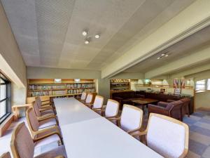 a library with a long table and chairs at Oze Iwakura Resort Hotel in Tokura +96 photos