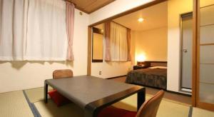 a room with a table and a bed and a bedroom at Hotel Kikuya in Hakodate +111 photos