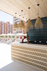 a restaurant with a counter with baskets on the wall at Hotel RH Arena - Todo Incluido in Gandía +18 photos