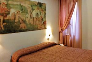 Postel nebo postele na pokoji v ubytování Albergo Elisa