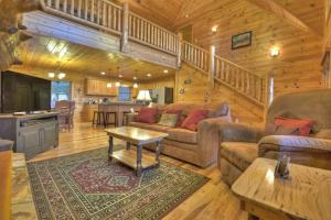 a living room with a couch and a table in a cabin at Sweet Seclusion Firepit king suite serene outdoor spaces in Mineral Bluff