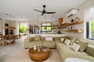 a living room with a couch and a table at La Brava Bali I Private Luxury Villas in Bingin, Uluwatu in Uluwatu