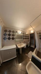 a bathroom with a sink and a toilet and a tub at Levantea Liv'In Italy in Marsala +33 photos