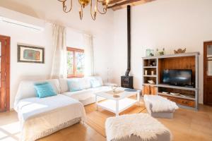 a living room with a white couch and a tv at Villa Marilen in Santa Margalida