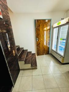 a lobby with a door and stairs in a building at Hotel Minar in Rohtak +19 photos