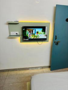 a flat screen tv on a wall in a room at Hotel Minar in Rohtak