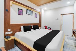 a bedroom with a large bed in a room at Collection O Ramakrishna Beach in Visakhapatnam