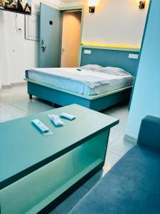 a room with two beds and two remote controls at Hotel Minar in Rohtak