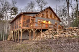 ein großes Holzhaus auf einem Hügel in der Unterkunft Holly Berry Hill - Walk to Lake Nottely, Unwind in the Hot Tub & Enjoy S’mores Under the Stars in Young Harris
