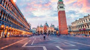 a large clock tower in a city with a building at ComeCasa 3 min walk from San Marco Apartment with beautiful roof terrace in Venice
