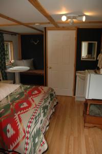 a bedroom with a bed with a christmas blanket at Gurus Of Gravel Bike Retreat Guest Cabin in Clearwater