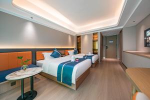 Postel nebo postele na pokoji v ubytování Xiamen Minyi Hotel