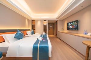 TV a/nebo společenská místnost v ubytování Xiamen Minyi Hotel