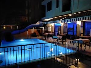 a swimming pool at night with a water slide at Livane Sun Otel in Alanya
