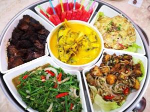 a tray filled with different types of food on a table at Lipis Plaza Hotel in Kuala Lipis +42 photos