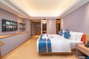 Postel nebo postele na pokoji v ubytování Xiamen Minyi Hotel