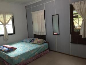 a bedroom with a bed in the corner of a room at Kiansom Getaway Cabin in Kota Kinabalu +41 photos
