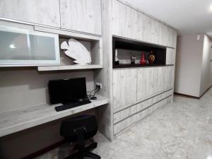 a room with a desk with a computer on it at Grand SH Hotel in Miri