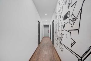 a hallway with black and white graffiti on the walls at Townhouse Oak Gomti Nagar Healthcity Vistaar in Lucknow