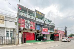 a building with a car parked in front of it at Alza 2 Cianjur Mitra RedDoorz in Tjiandjur
