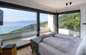 a bedroom with two beds and large windows at Stunning Home In Medveja in Medveja