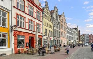 a city street with buildings and people walking down the street at 1 Bedroom Stunning Apartment In Wismar in Wismar