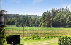 a swing in the middle of a field at 3 Bedroom Nice Home In Grenaa in Brøndstrup +11 photos
