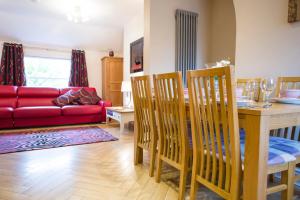 a living room with a table and a red couch at Chester Apartments in Chester
