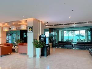 a lobby of a building with orange furniture and windows at Golden Dragon Beach Resort Pattaya (Bang Lamung) in Ban Rong Po +100 photos