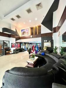 a large lobby with black couches in a building at Adamson Hotel Kuala Lumpur in Kuala Lumpur